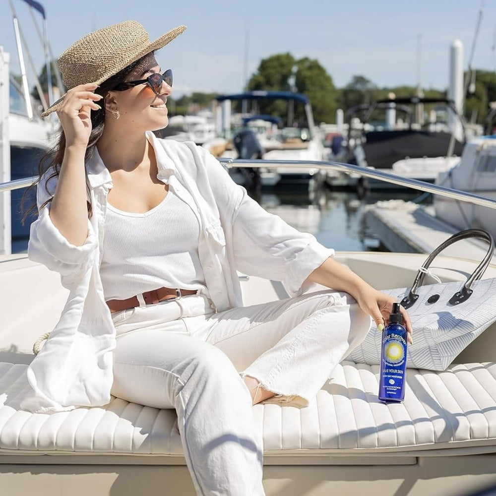 Flatlay of Solar Recover with sunscreen and towel showing perfect travel essentials benefit