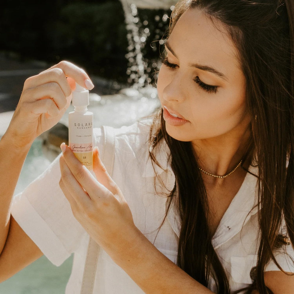 Model applying Solara Suncare under makeup demonstrating non-greasy base benefit