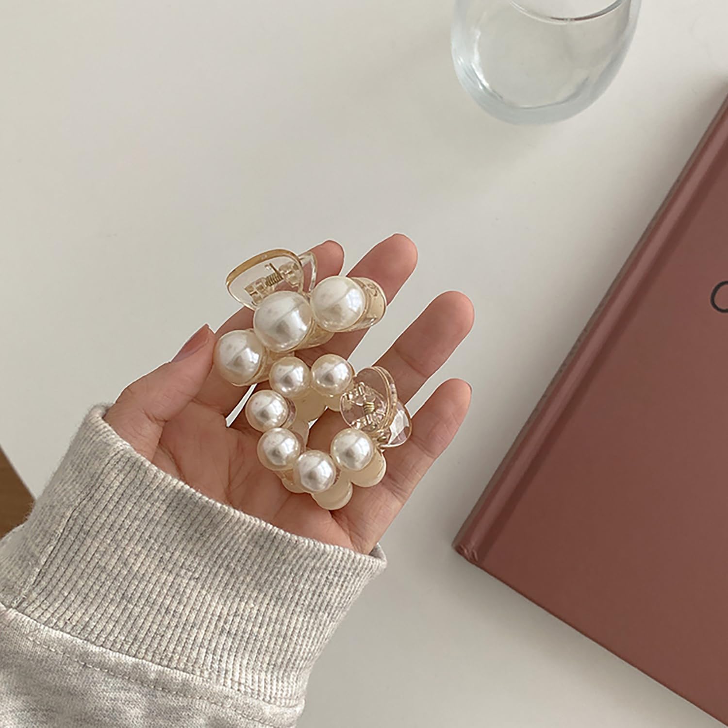 SONGJIE clip in hand for scale showing compact, travel-friendly benefit