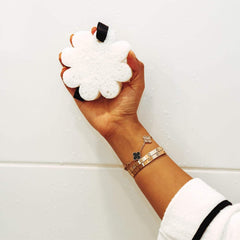 SPONGELLÉ applying sponge to skin showing moisturized, radiant finish