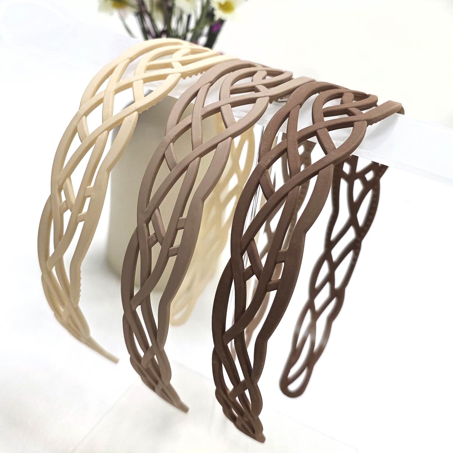 Springtime headband held in hand to show scale and ease of use for on-the-go styling