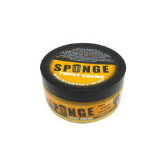 Hand scooping Spunge creme texture showing smooth application and control
