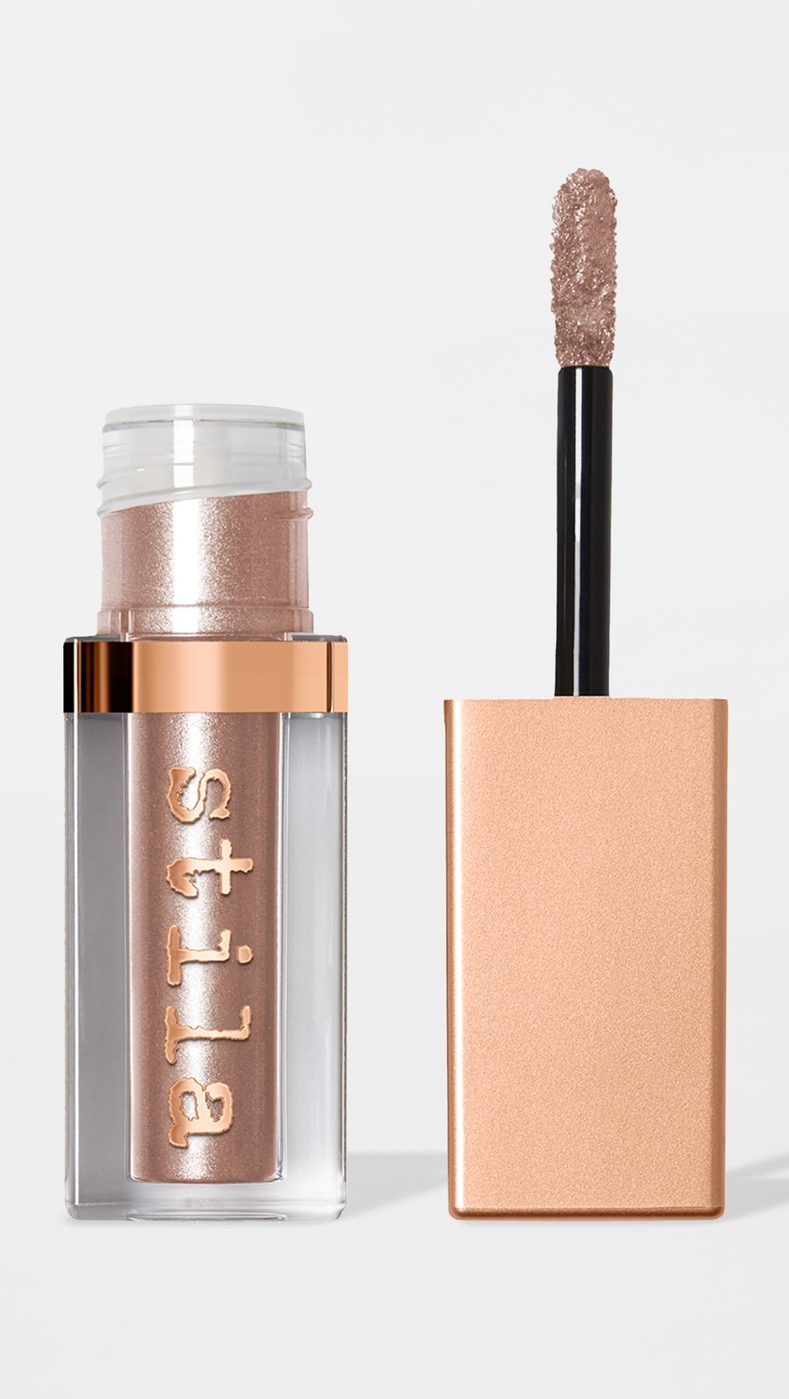 stila tube next to coin showing 0.15 fl oz size for travel-friendly convenience