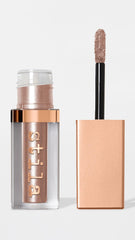 stila tube next to coin showing 0.15 fl oz size for travel-friendly convenience
