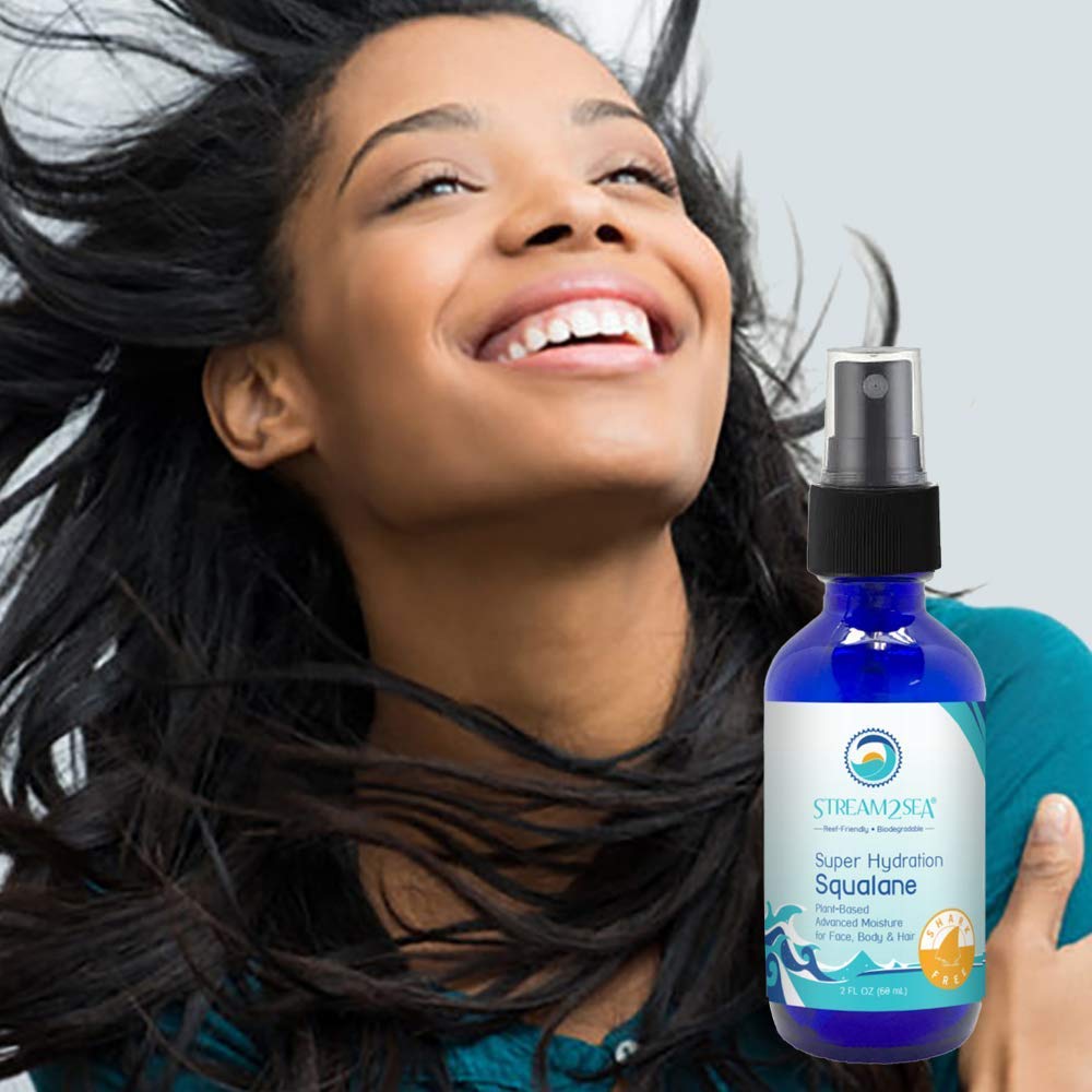STREAM 2 SEA smoothing oil into hair ends to reduce breakage and frizz