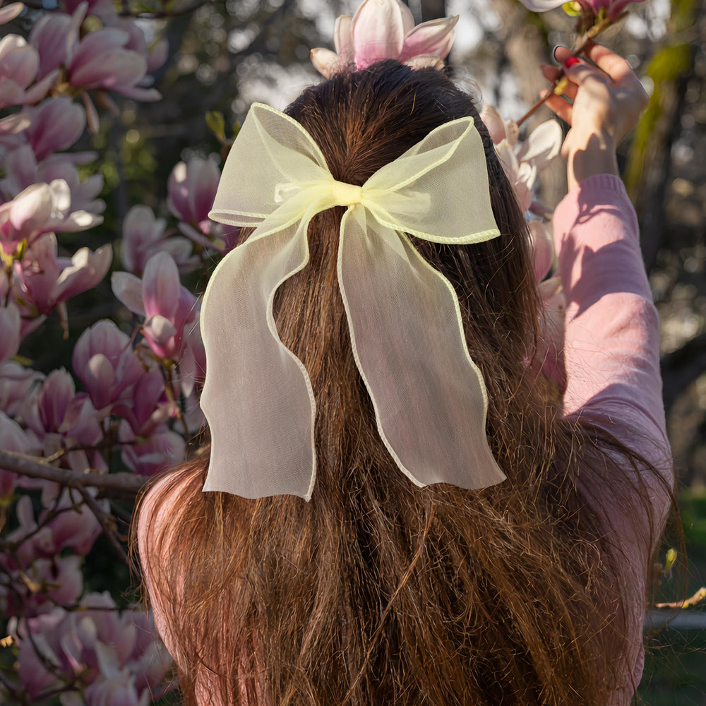 STSTR bow with hand for scale showing size and proportion benefit: easy styling reference