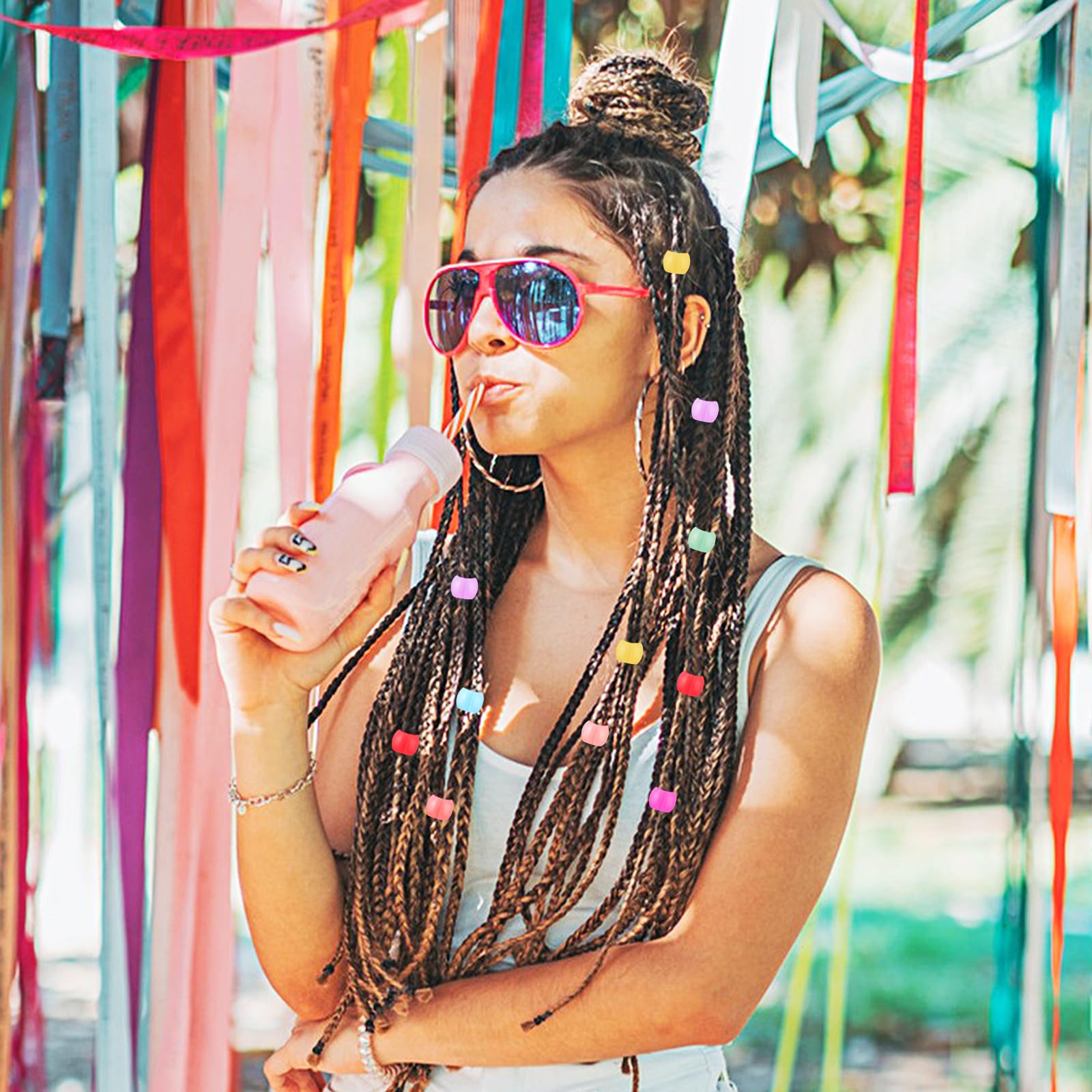 Styquenzer beads clipped in child braids adding playful color accents