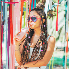 Styquenzer beads clipped in child braids adding playful color accents