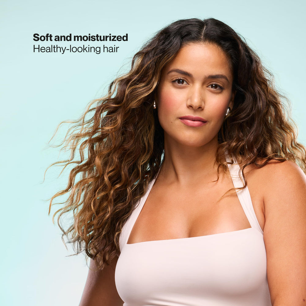 Suave conditioner pouring onto mid-lengths demonstrating smooth detangling benefit
