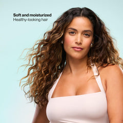 Suave conditioner pouring onto mid-lengths demonstrating smooth detangling benefit