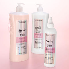 Suave bottles next to hand for scale showing full-size 28 oz value