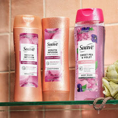 Suave bottles held in hand showing 12.6 oz scale and travel suitability