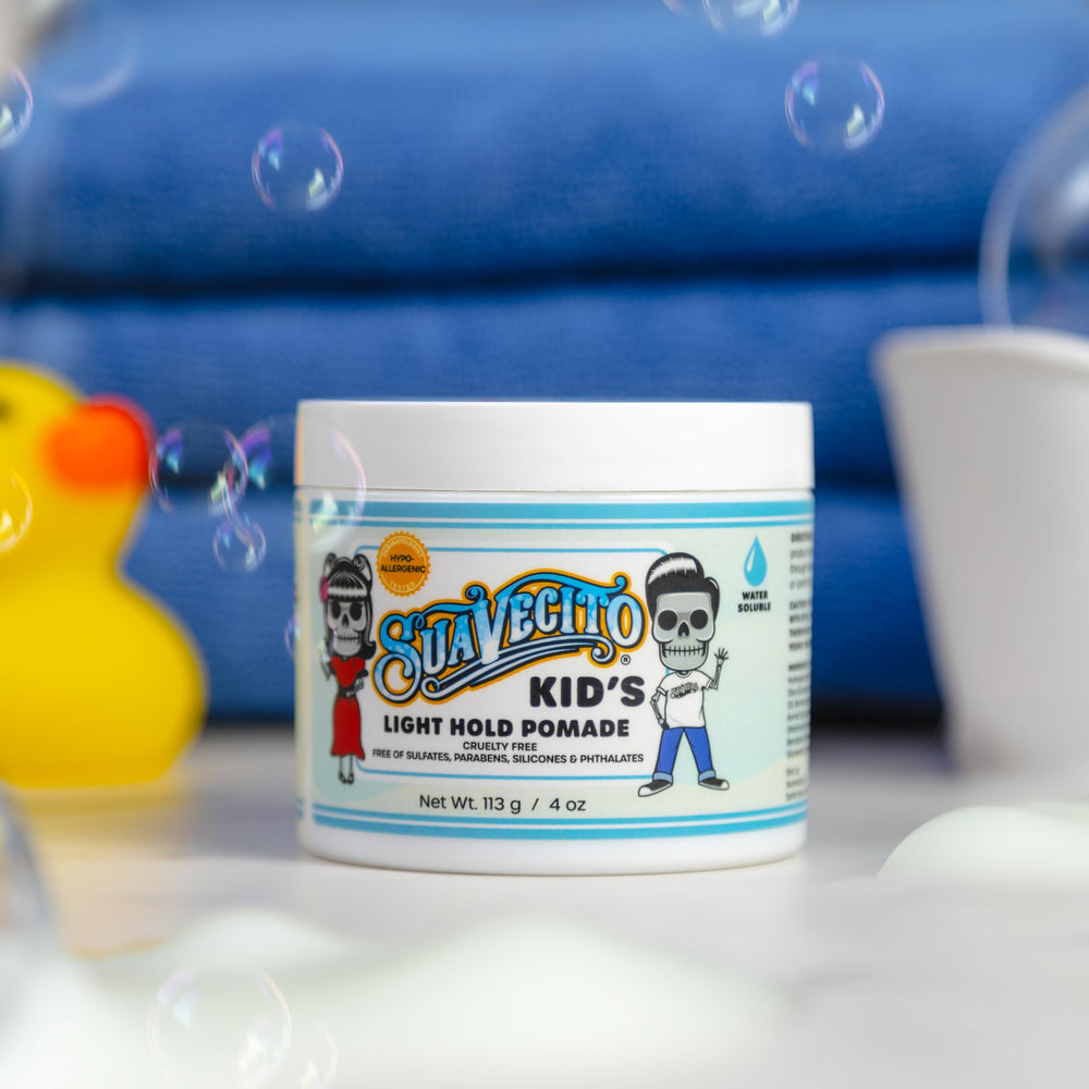 Smiling child styled with Suavecito showcasing natural, soft hair