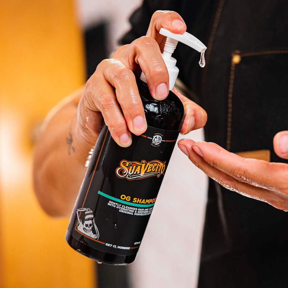 Suavecito OG shampoo held in hand to show 16 oz scale and travel convenience