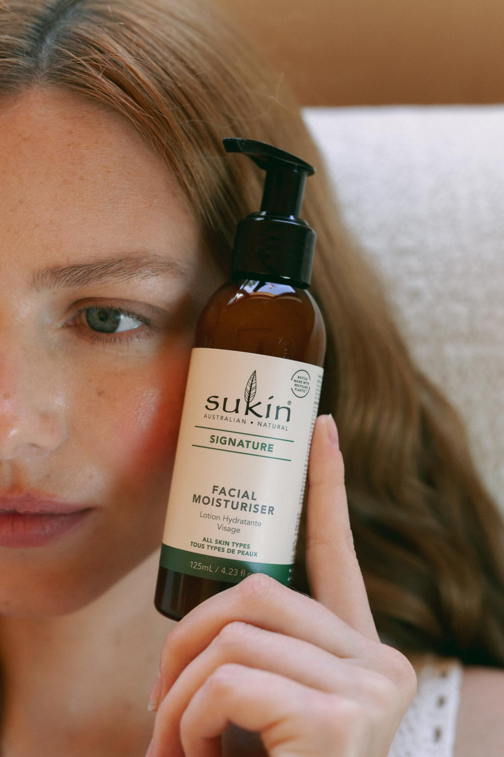 Sukin tube held in hand showing scale and travel-friendly benefit