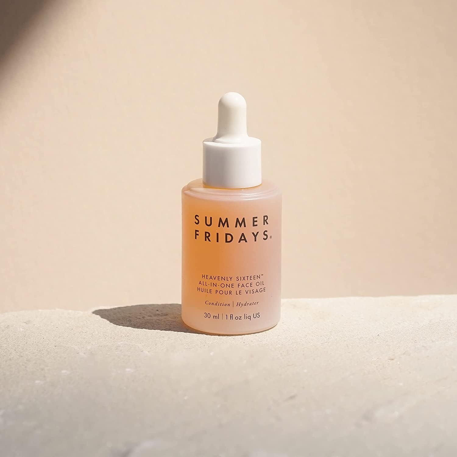 Summer Fridays dropper dispensing a clear drop of oil highlighting precise application