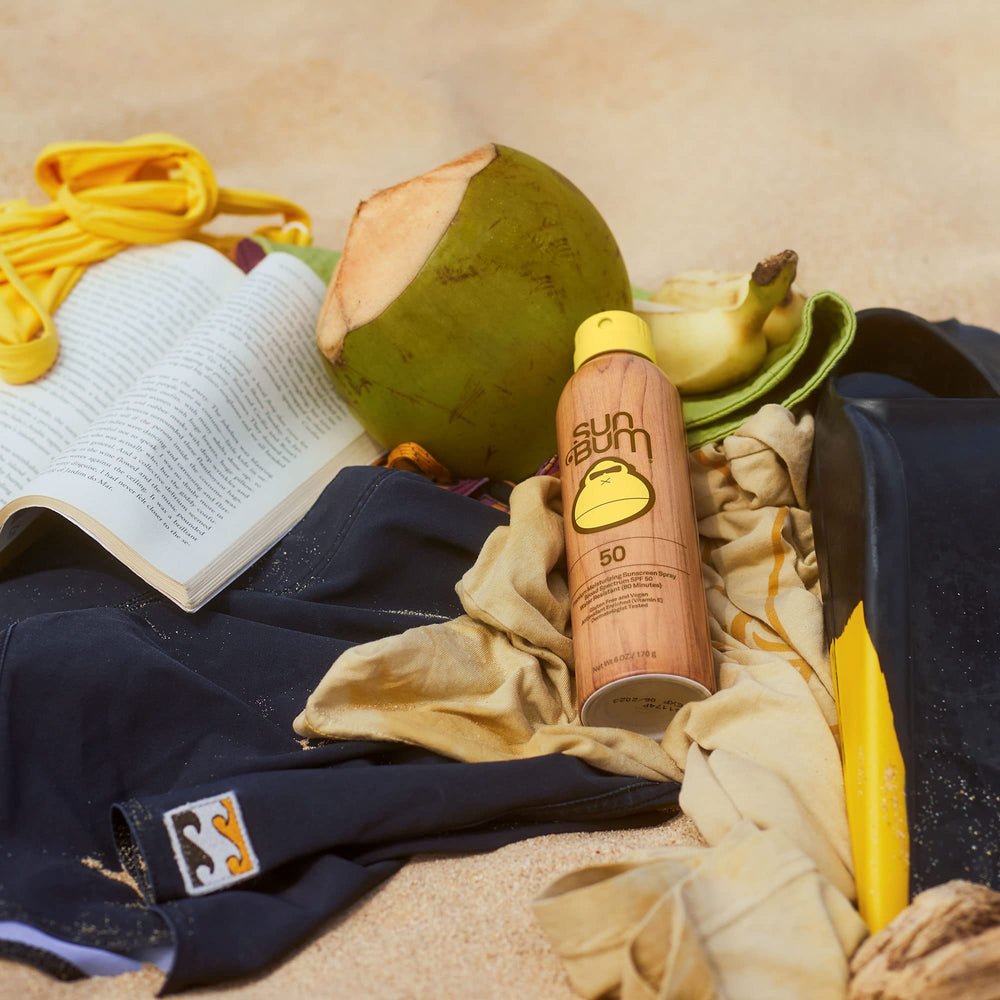 Sun Bum next to hand to show 6 oz size and travel-friendly benefit