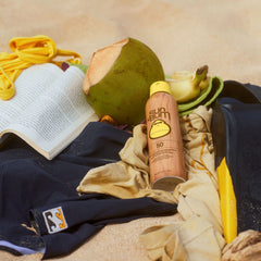 Sun Bum next to hand to show 6 oz size and travel-friendly benefit