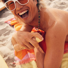 Sun Bum spraying mist in motion for fast, even application benefit