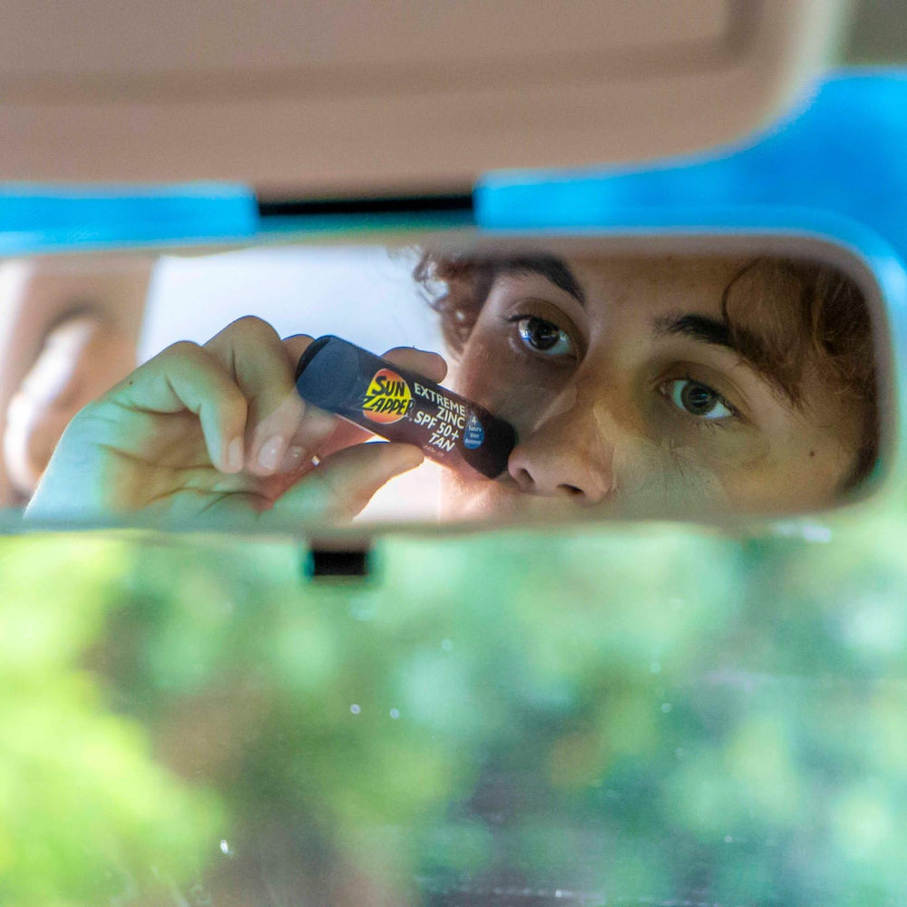 Applying Sun Zapper to nose and cheeks for targeted sun protection benefit