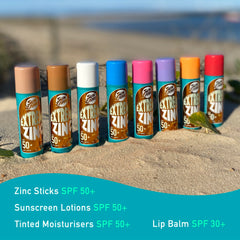 Sun Zapper sticks on beach with surfer showing real-world surf performance and visibility benefit