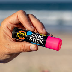 Sun Zapper sticks in a beach bag setting showing quick reapplication during outings
