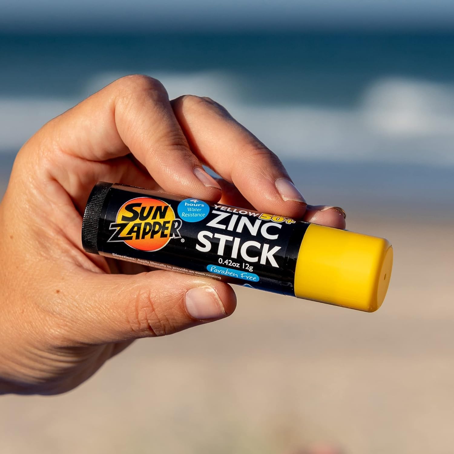 Sun Zapper next to a hand for scale showing travel-sized convenience