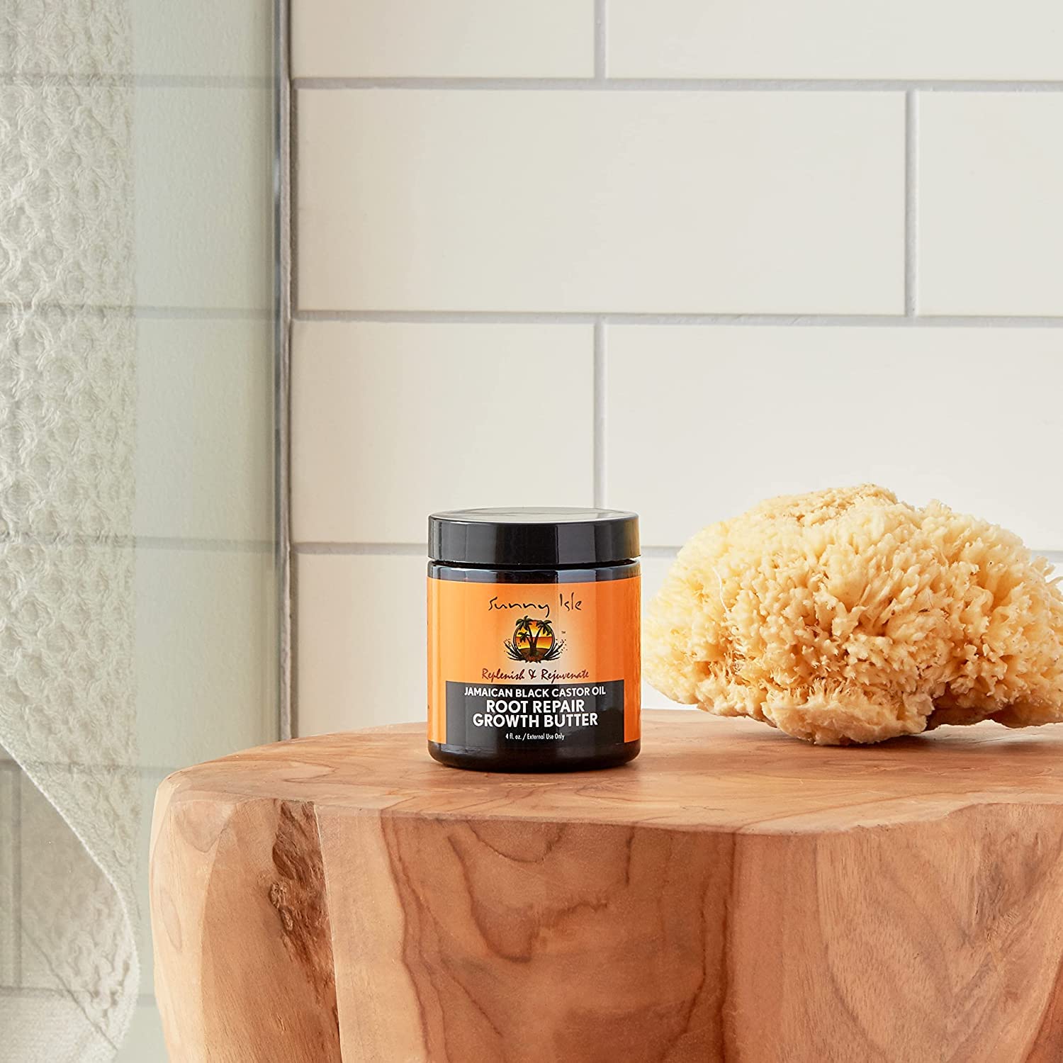 Sunny Isle butter on bathroom shelf suggesting daily moisturizing routine