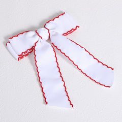 SUPCLIPS bows displayed with outfit and gift box, ready for occasions