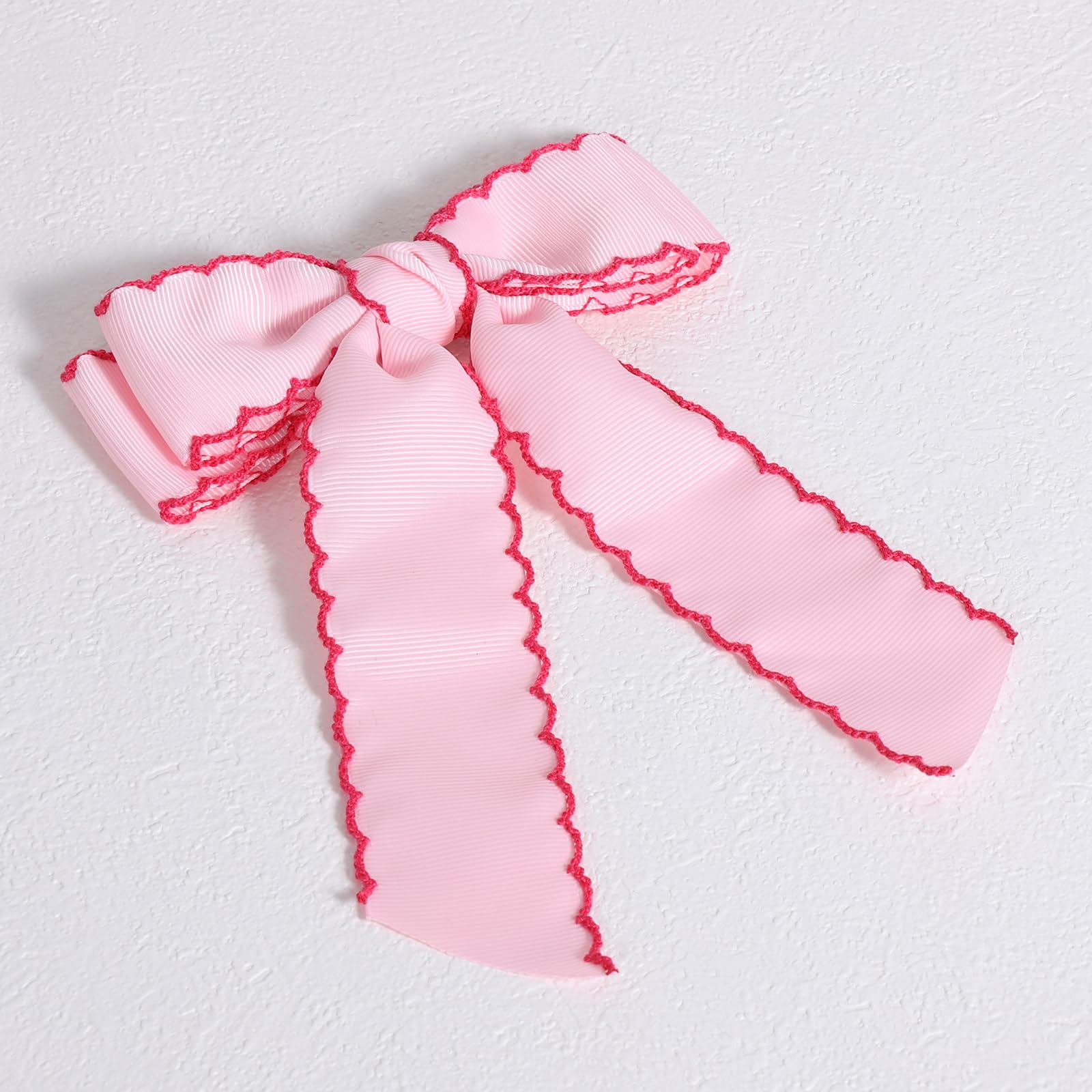 SUPCLIPS flatlay styled outfit with bow showing coordination and visual impact