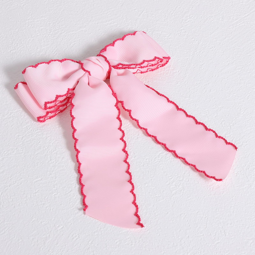 SUPCLIPS flatlay styled outfit with bow showing coordination and visual impact