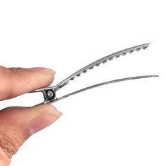 Super Z Outlet clips used by stylist sectioning hair for color with firm, non-slip hold