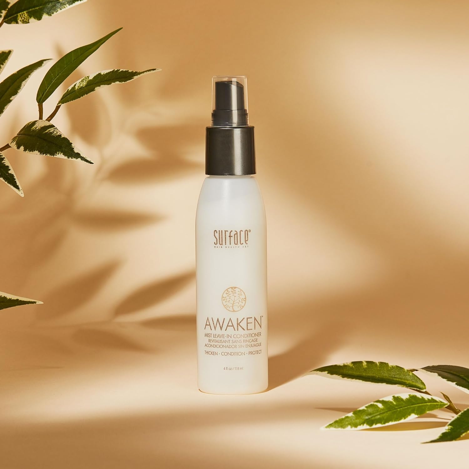 SURFACE awaken mist spraying onto hair roots demonstrating lightweight application and detangling benefit