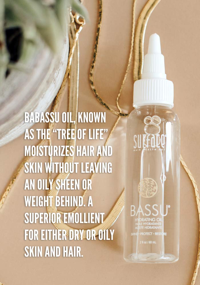 SURFACE Bassu oil being applied to hair mid-lengths demonstrating frizz control benefit