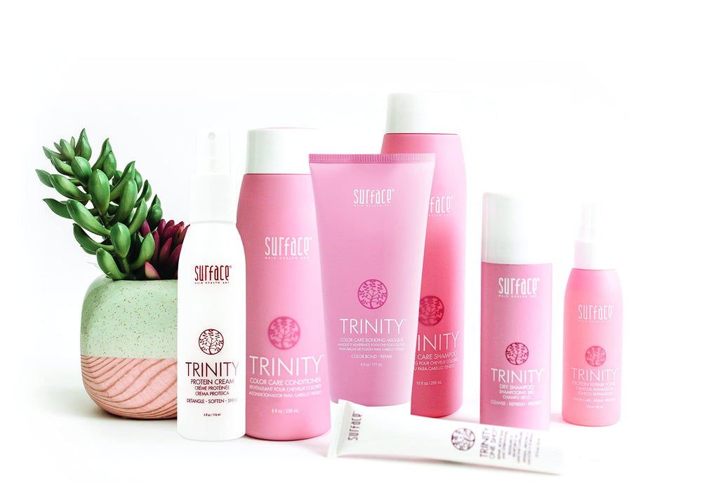Surface product being applied to damp hair to detangle and add shine
