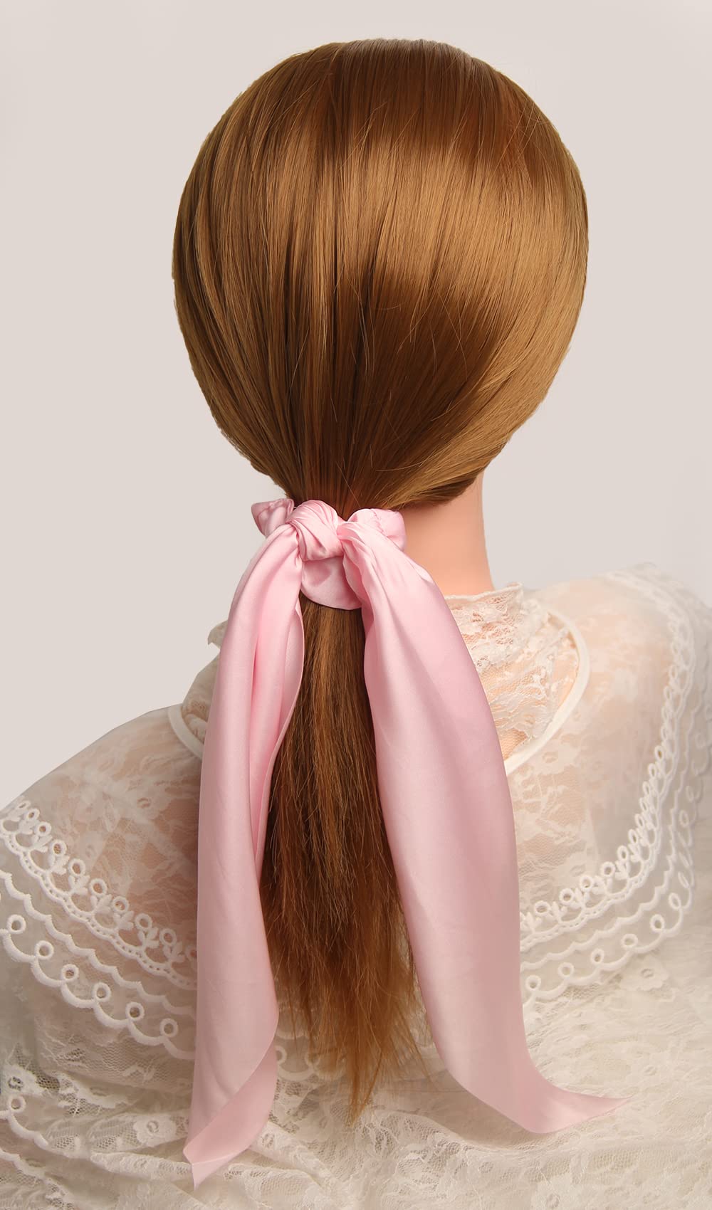 SUSULU scrunchie held in hand to show actual size and lightweight portability benefit