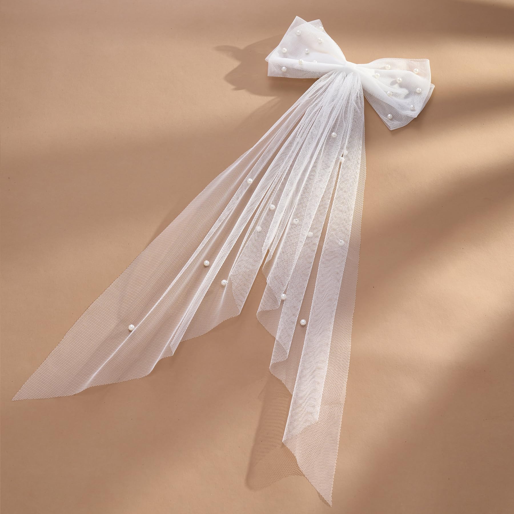 SWEETV bow held in hand for size scale emphasizing compact portability