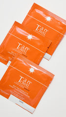 Person applying Tan Towel towelette to leg demonstrating fast even bronzing on the go