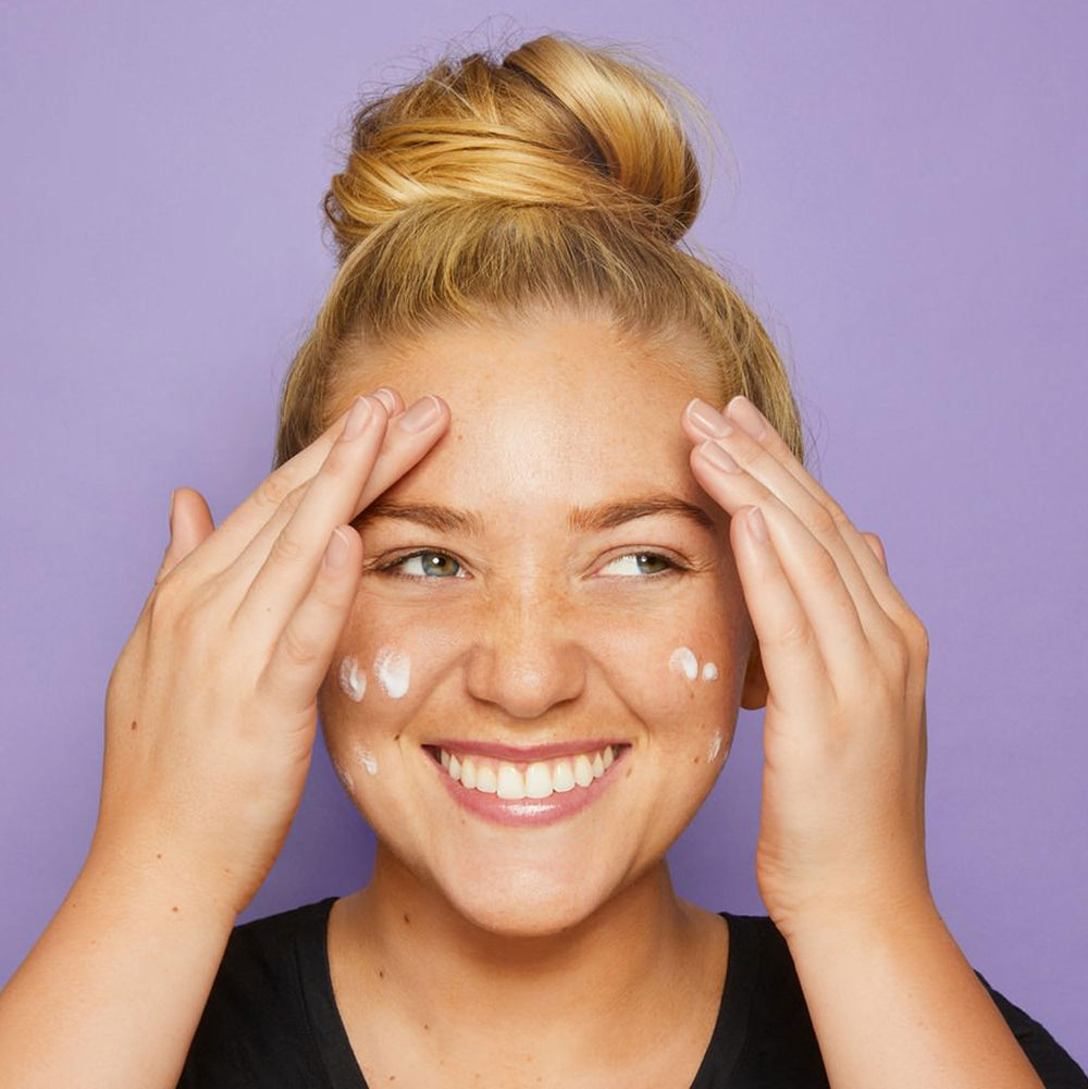tarte base tape held in hand to show size and portable design benefit
