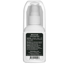 Tattoo Goo mist dispersing over piercing demonstrating gentle, even saline rinse