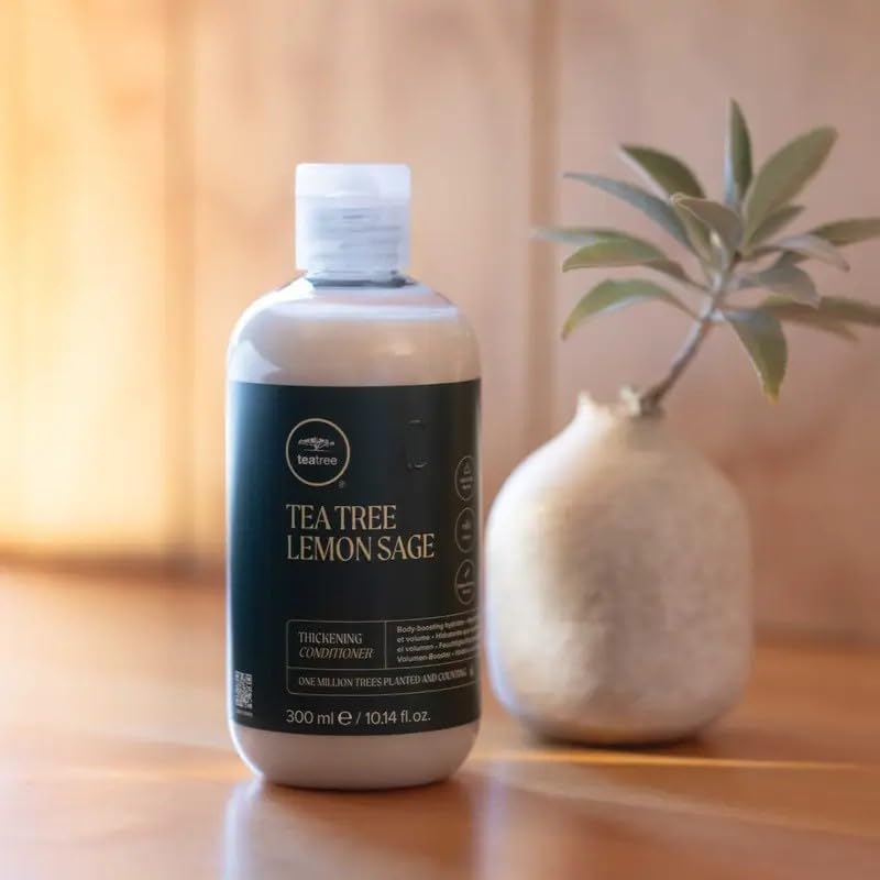 Tea Tree conditioner being applied in shower, demonstrates detangling and smooth benefit