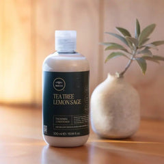 Tea Tree conditioner being applied in shower, demonstrates detangling and smooth benefit