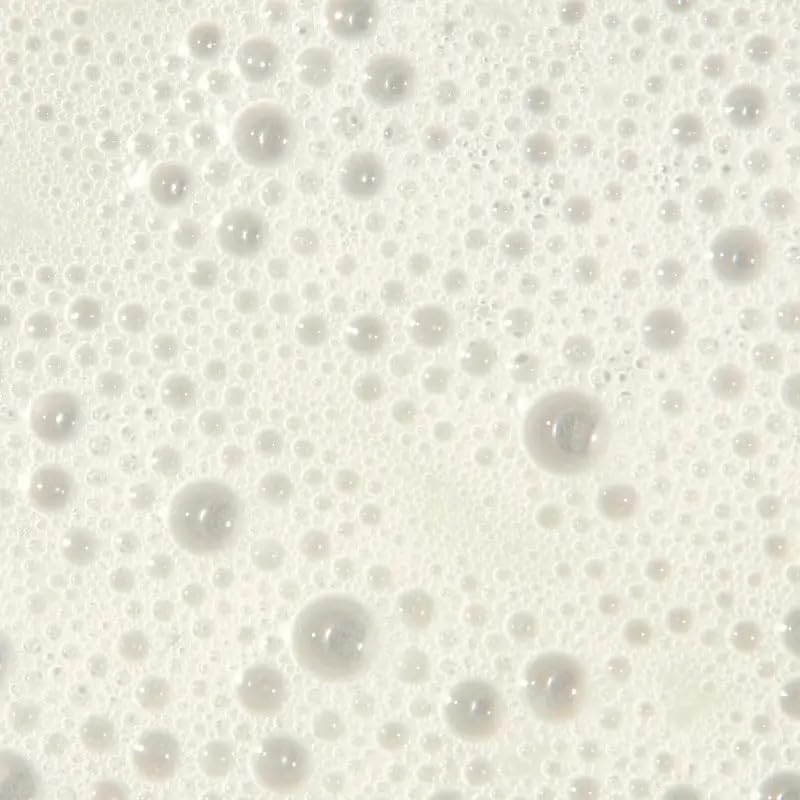Tea Tree bottle on shower shelf in bathroom setting suggesting invigorating wash