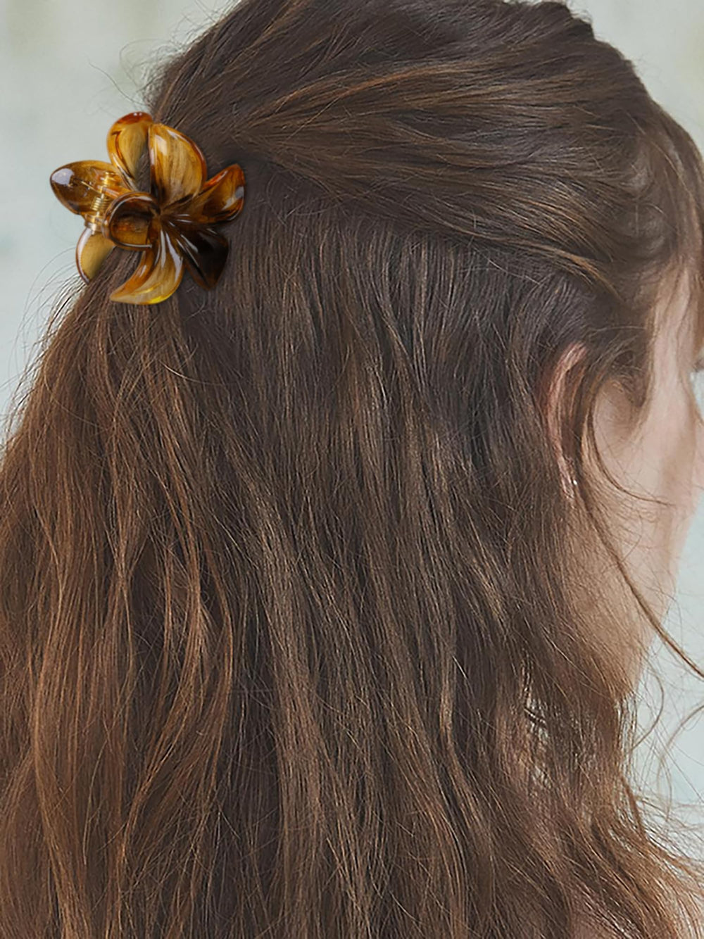 TEBIEKOY clipped in hair half-up style adding a playful floral accent