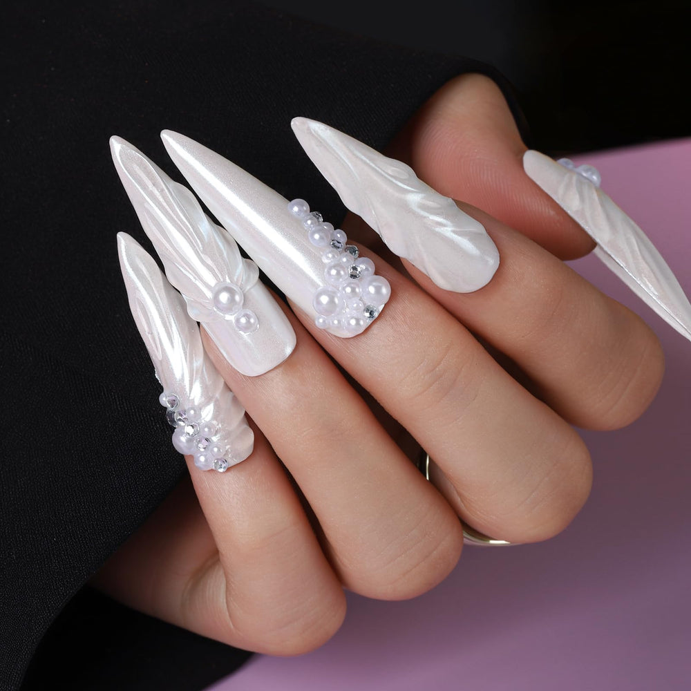 Teenitor nail gems and charms arranged to display rhinestones, pearls, shells and beads