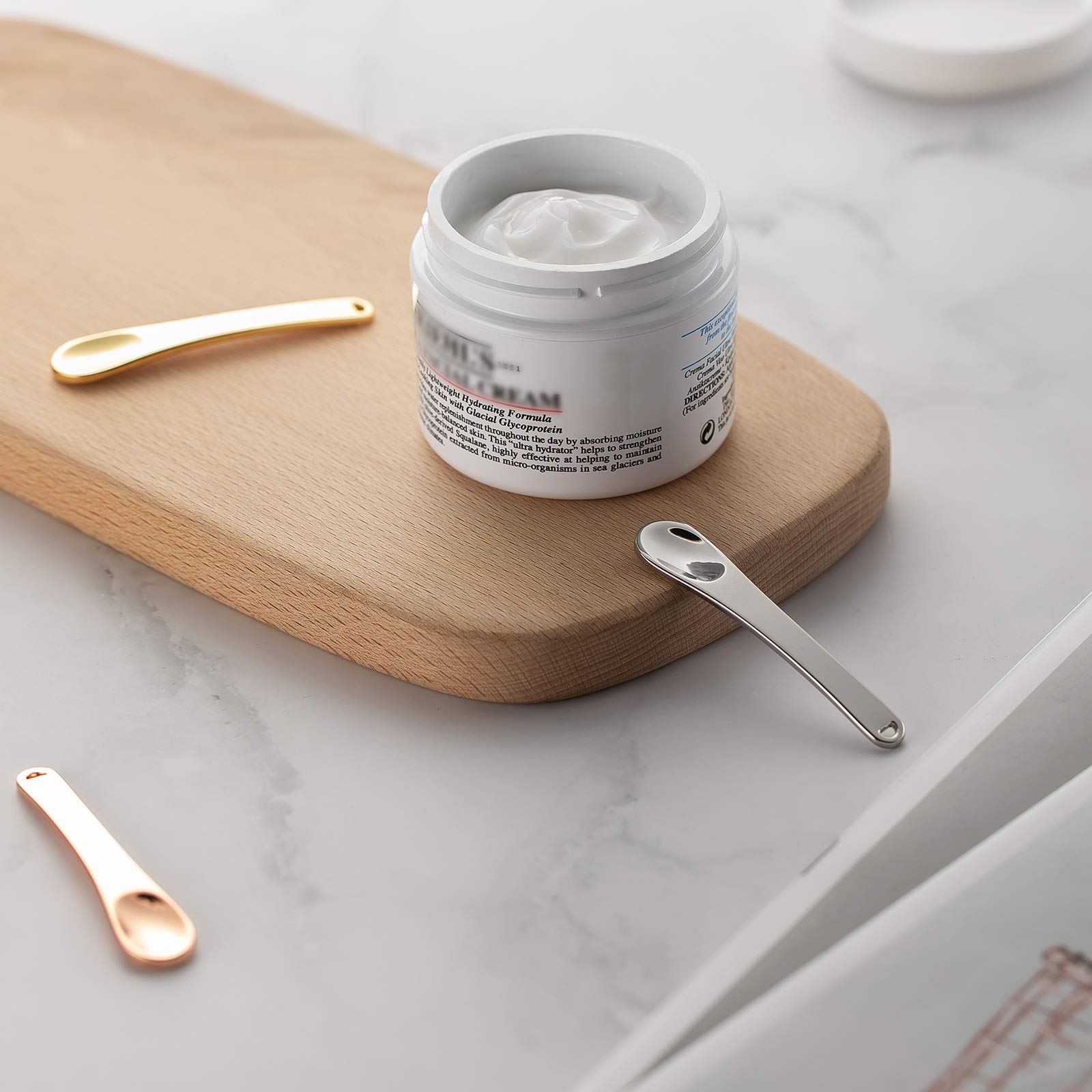 Tekson scooping skincare cream demonstrating sanitary application without fingers