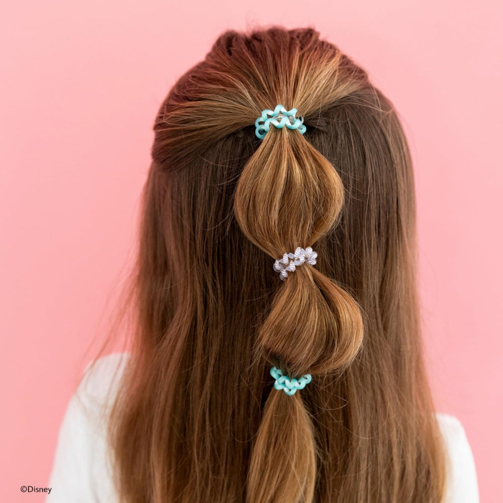 Teleties tiny hair ties beside a coin showing size and gentle-hold benefit