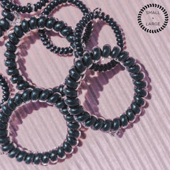 Teleties jet black under water droplets showing water‑resistant quick‑dry benefit