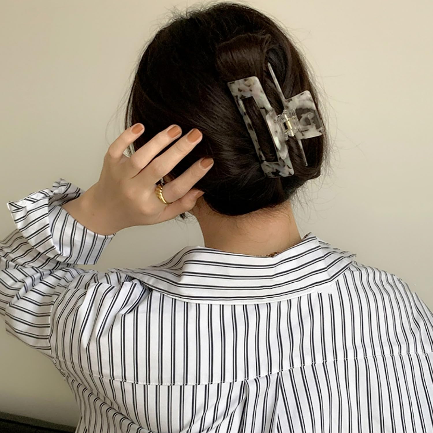 Textention clip in use securing thick curly hair for comfortable all-day wear