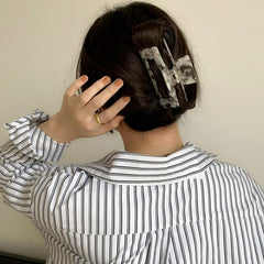 Textention clip in use securing thick curly hair for comfortable all-day wear